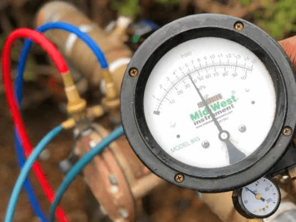 Backflow testing gauge and valves in close-up, from the B. Spontak website