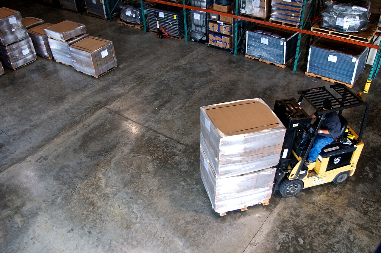 Warehouse interior with a forklift moving stock